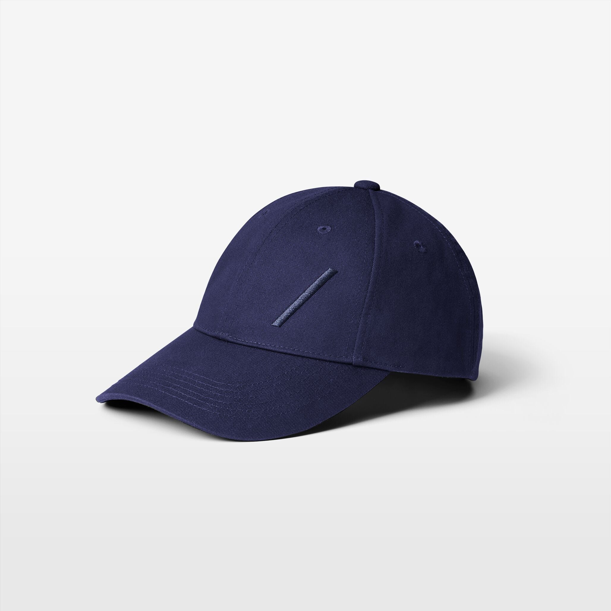 Volvo Classic Cap in navy, featuring an embroidered diagonal logo. Cut-out image with a plain background. 