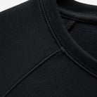 The Volvo Sweatshirt in black. It features a diagonal print with reflective gloss and a classic crewneck style.