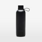 The Volvo Thermos Bottle in black against a white background. We see the rust-proof stainless steel design, tight sealing ring, Volvo logo near the bottom, and strap for easy carrying.