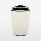 The Volvo Travel Mug in off-white against a white background. In rust-proof stainless steel and with insulated design, we see the Volvo logo near the bottom and the liquid-tight seal at the top.