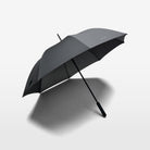 The large, lightweight and durable Volvo Umbrella seen open against a white background. Visible is the recycled yarn material and the Volvo logo in small, stylish lettering.
