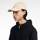 The Volvo Classic Cap in dune, worn by a male model. It features an embroidered diagonal logo on the side. 