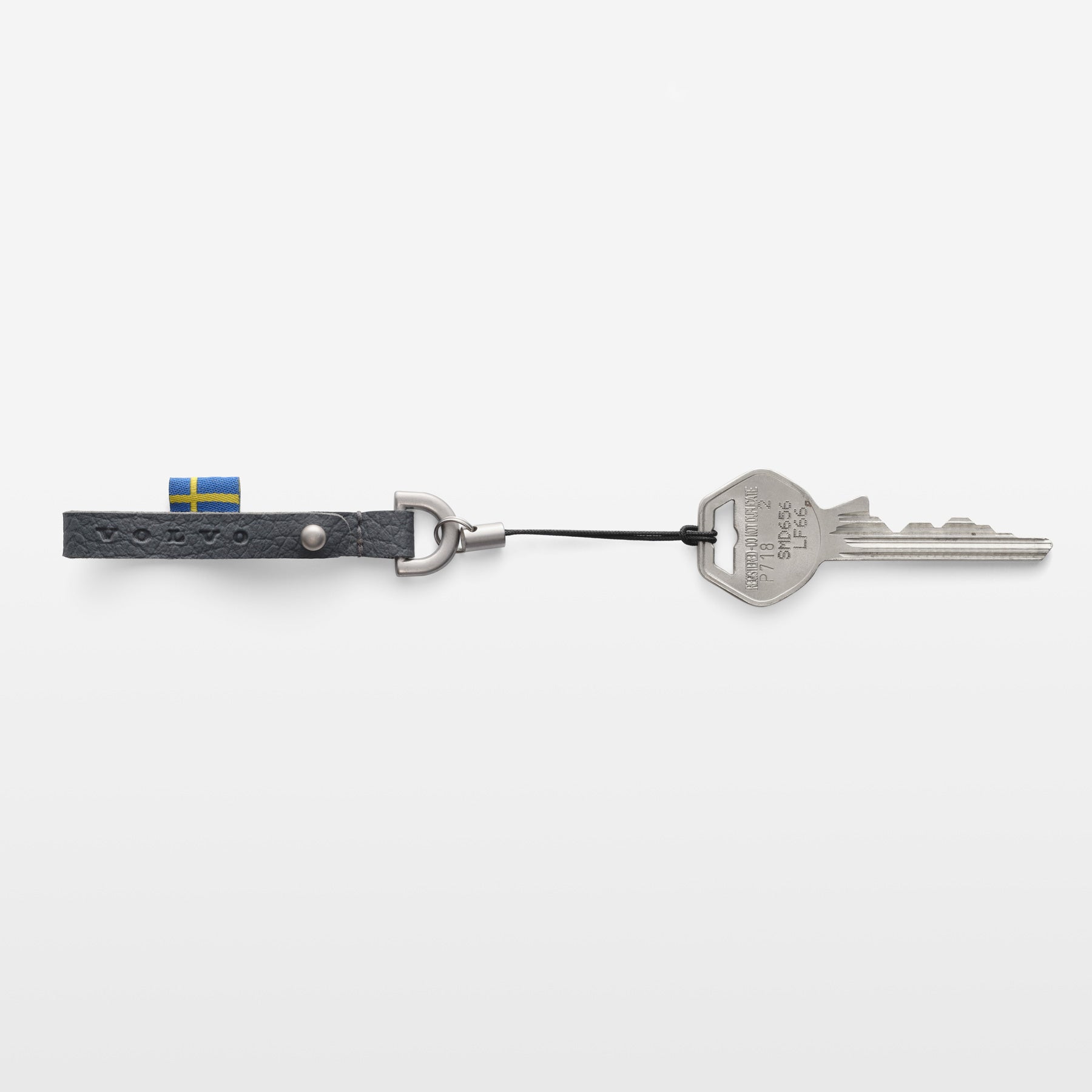 Keychain with a key and a flag attached on a white background
