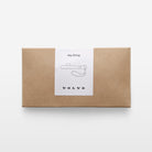 Kraft paper box with a Volvo key string label on a white background