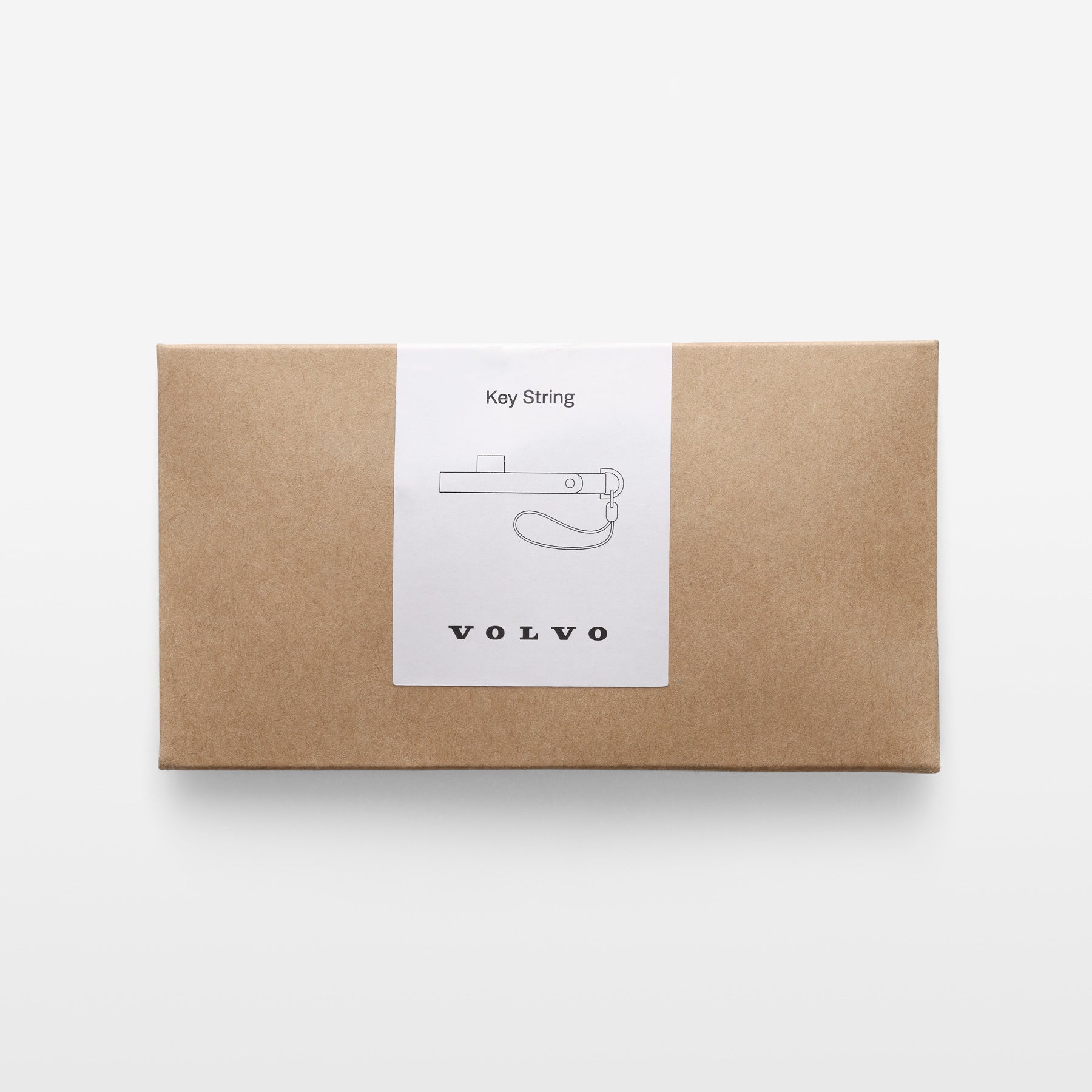 Kraft paper box with a Volvo key string label on a white background