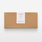 A rectangular brown kraft paper box with a white paper label on the front that reads 'Key Card Holder' with a simple key card icon and the brand name 'VOLVO' below it, photographed on a clean white background.