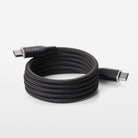 Coiled black USB cable on a white background