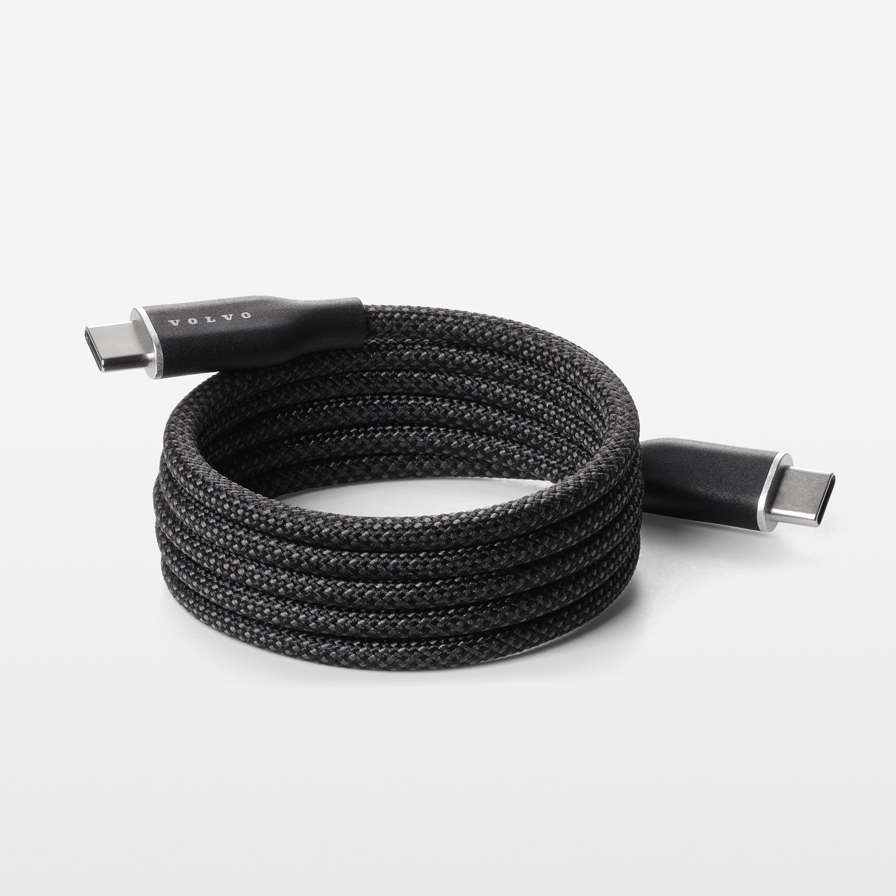 Coiled black USB cable on a white background