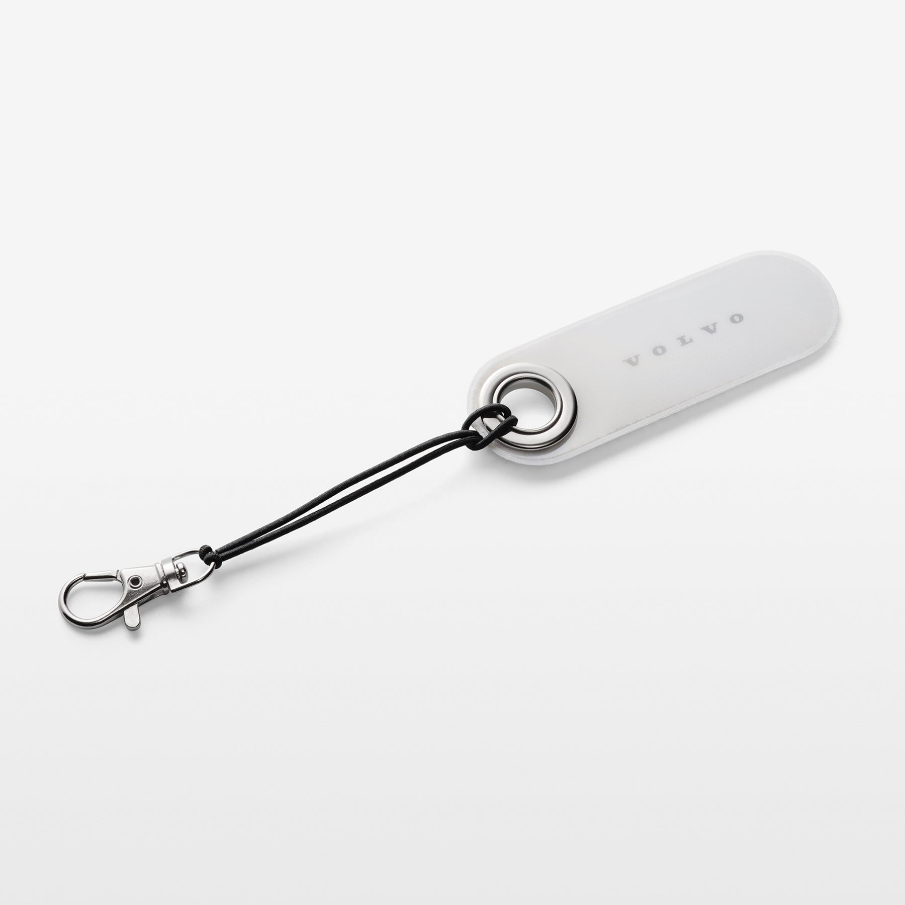 White reflective tag with black strap on a light gray background
