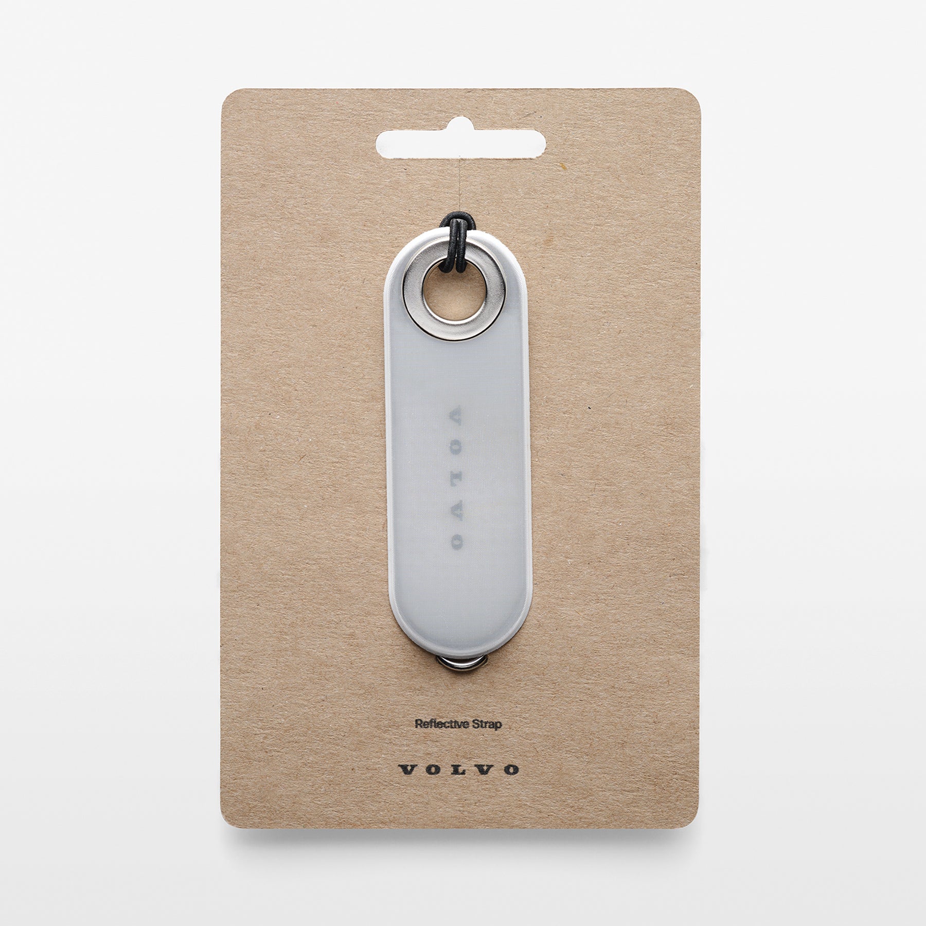 Reflective strap on a beige card with Volvo branding