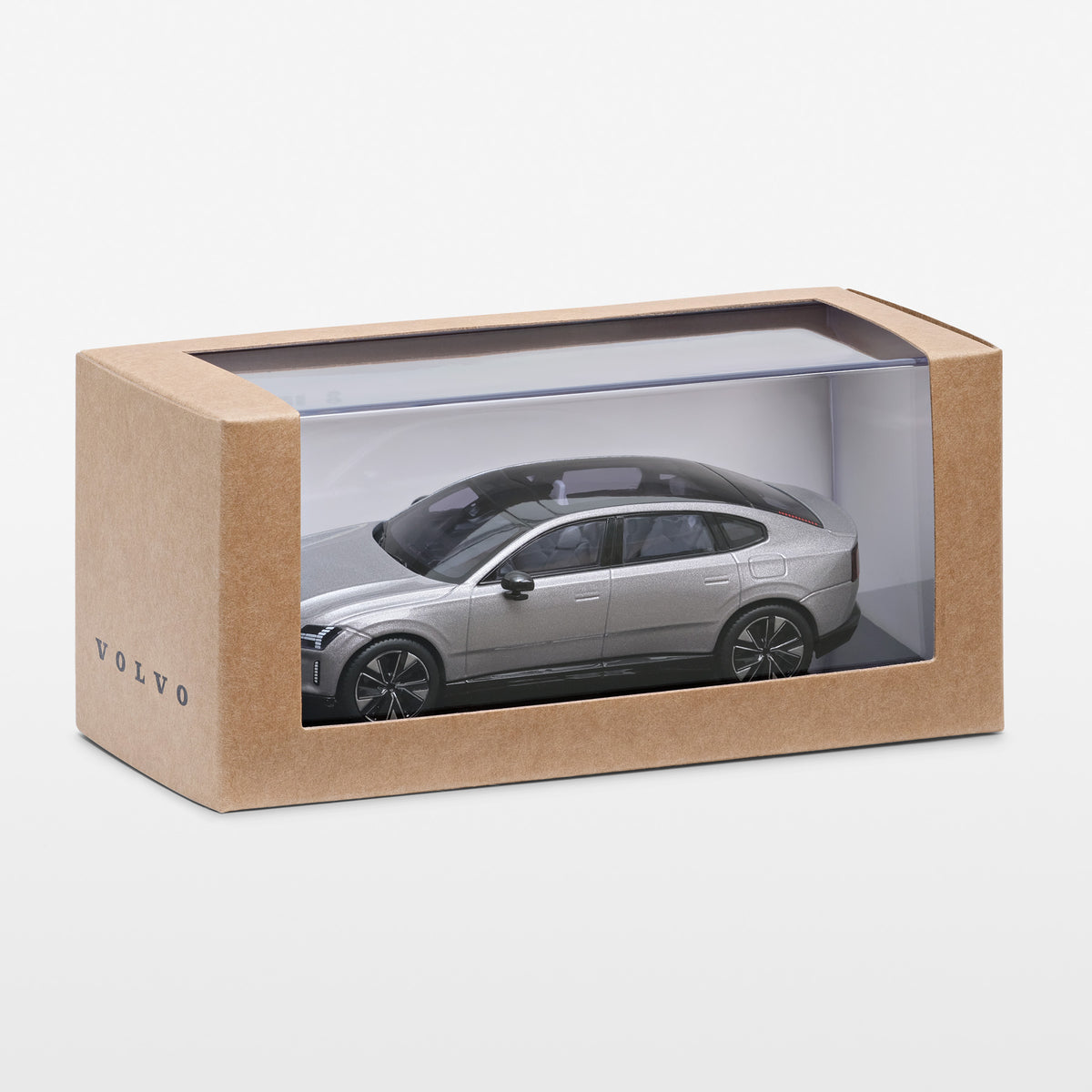 A silver Volvo model car displayed inside a clear-front brown cardboard box on a light gray background.
