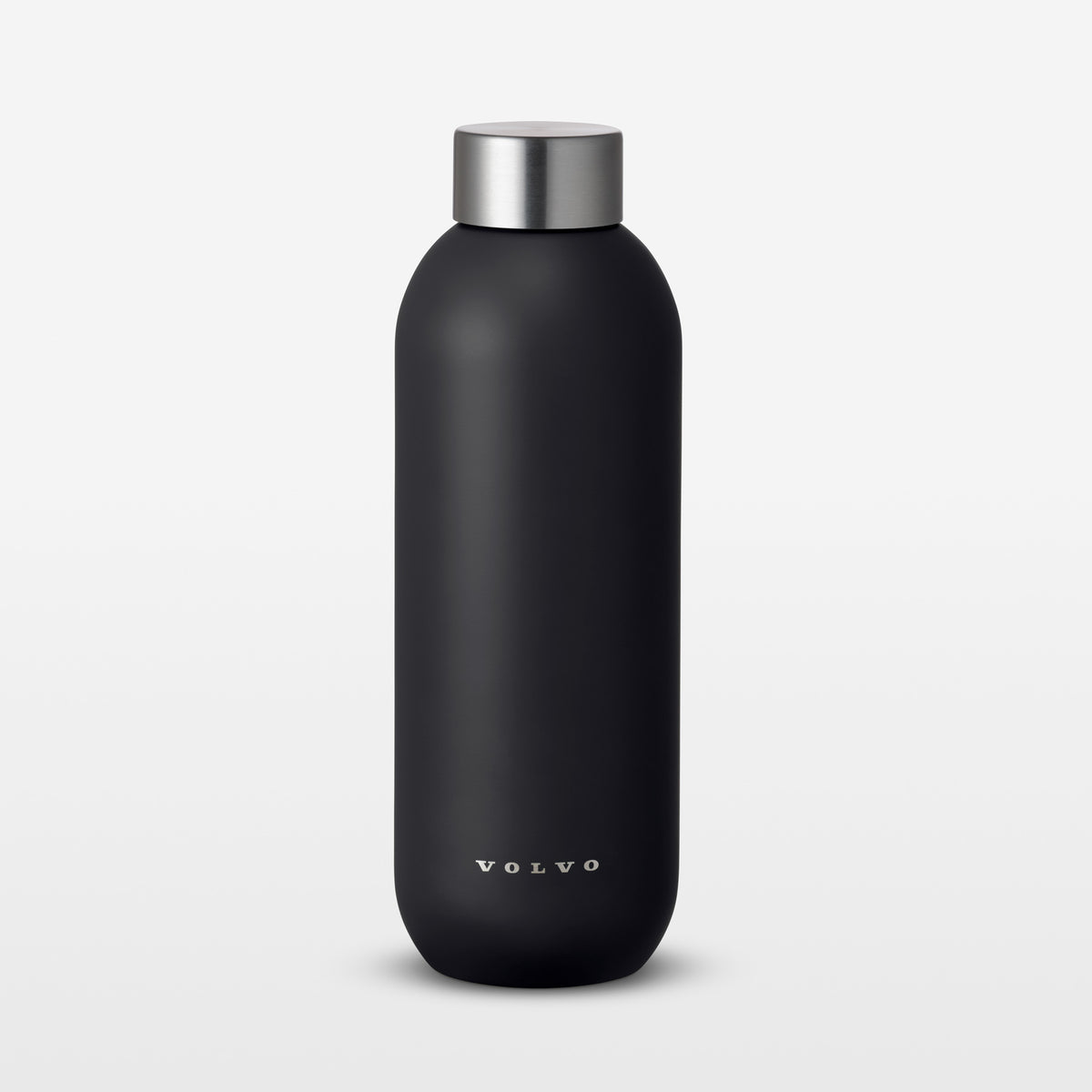 Black water bottle with silver cap on a light gray background