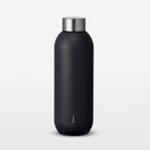 Black water bottle with silver cap on a light gray background
