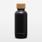A matte black Volvo water bottle with a natural cork stopper, shown on a clean white background.